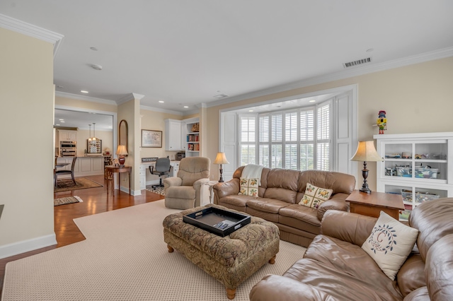 living room featuring crown molding and hardwood / wood-style floors