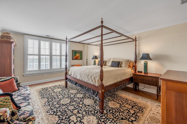 bedroom with crown molding and light hardwood / wood-style flooring