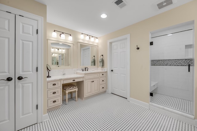 bathroom with vanity and a tile shower