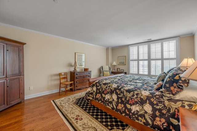 bedroom featuring light hardwood / wood-style flooring and ornamental molding