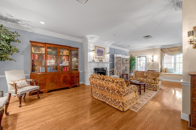 living room featuring light hardwood / wood-style flooring and crown molding