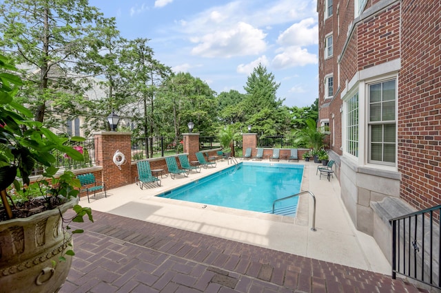 view of swimming pool with a patio area