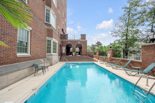 view of swimming pool with a patio