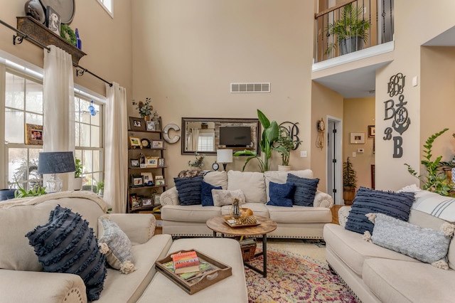 living room with a wealth of natural light and a high ceiling