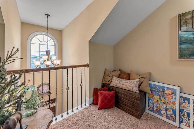 interior space with carpet flooring, lofted ceiling, and an inviting chandelier