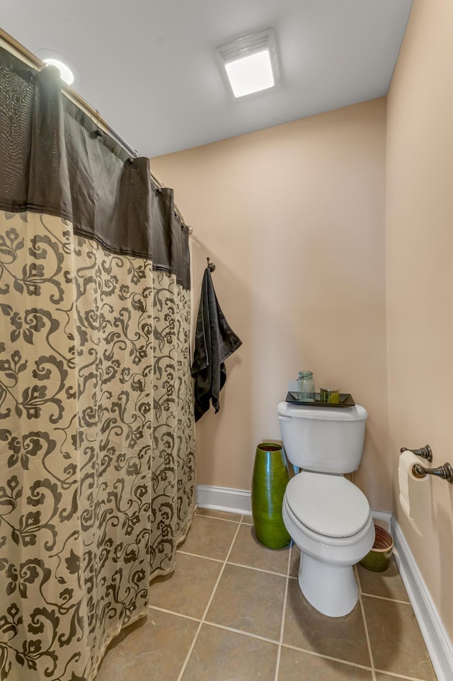 bathroom featuring tile patterned floors and toilet