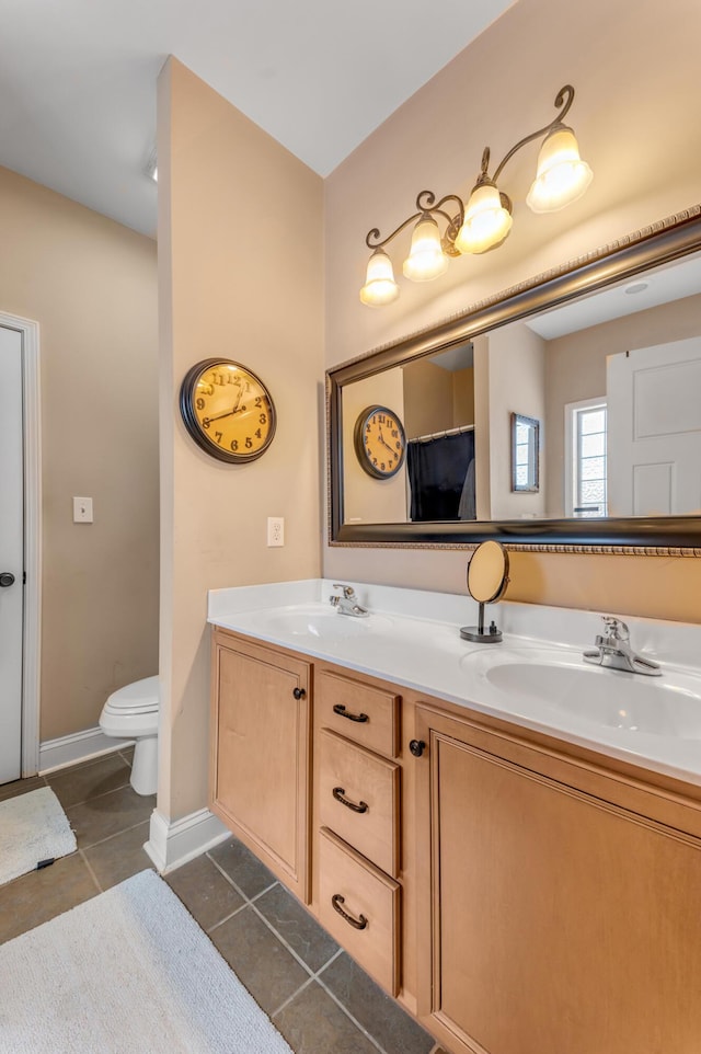 bathroom with tile patterned floors, vanity, and toilet