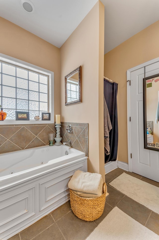 bathroom with independent shower and bath and tile patterned flooring