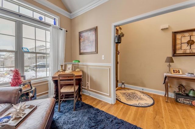 sitting room with lofted ceiling, crown molding, and hardwood / wood-style floors