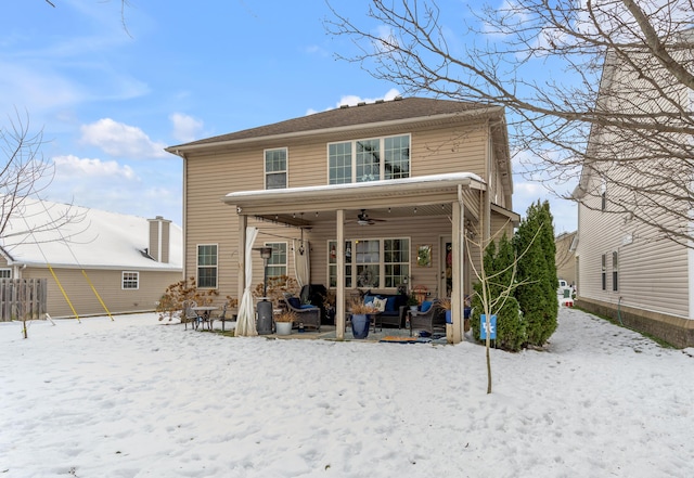 snow covered rear of property featuring ceiling fan