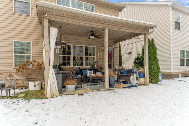 snow covered patio with ceiling fan and outdoor lounge area