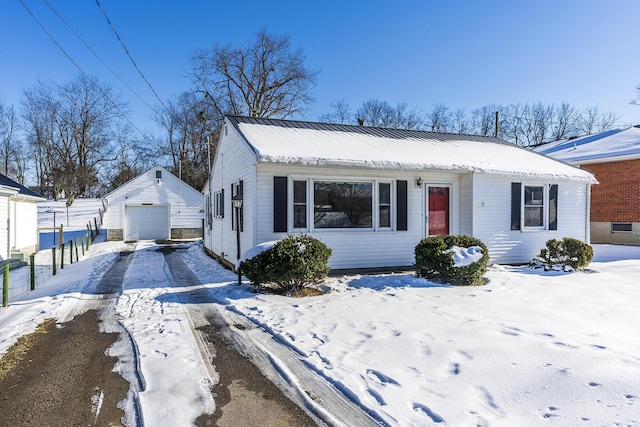 view of front of home with a garage and an outdoor structure