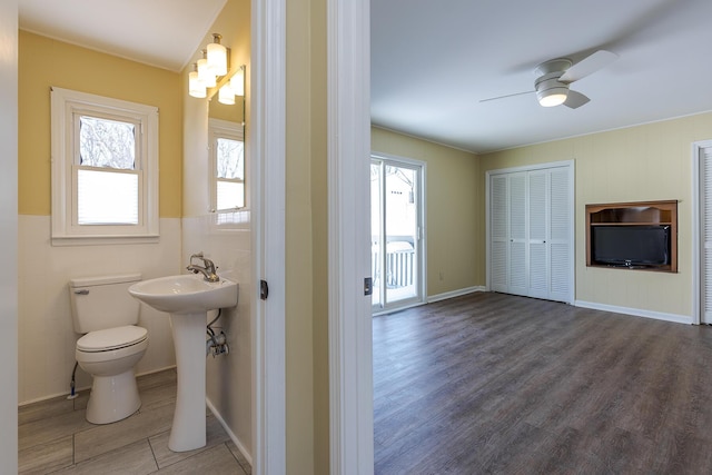 bathroom with toilet, ceiling fan, and hardwood / wood-style flooring