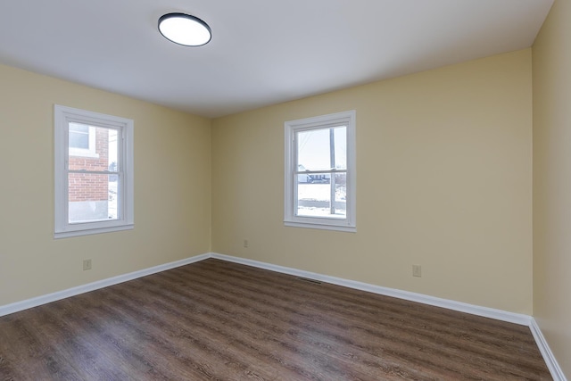 unfurnished room featuring dark wood-type flooring