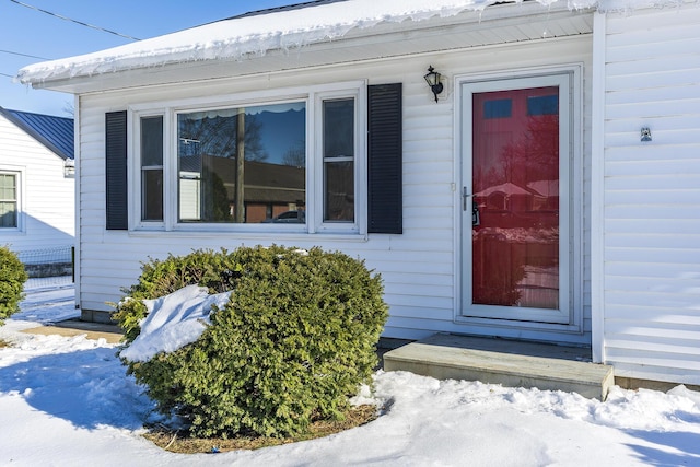 view of snow covered property entrance