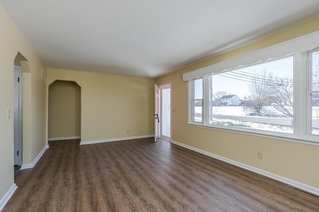 spare room with dark wood-type flooring