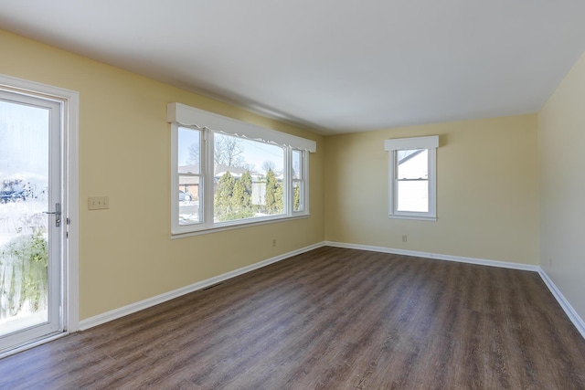 unfurnished room with dark wood-type flooring