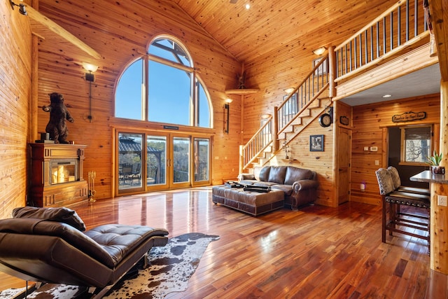 living room featuring high vaulted ceiling, wood walls, wood ceiling, and hardwood / wood-style floors