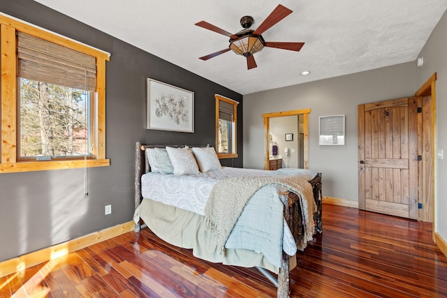 bedroom featuring ceiling fan and dark hardwood / wood-style floors