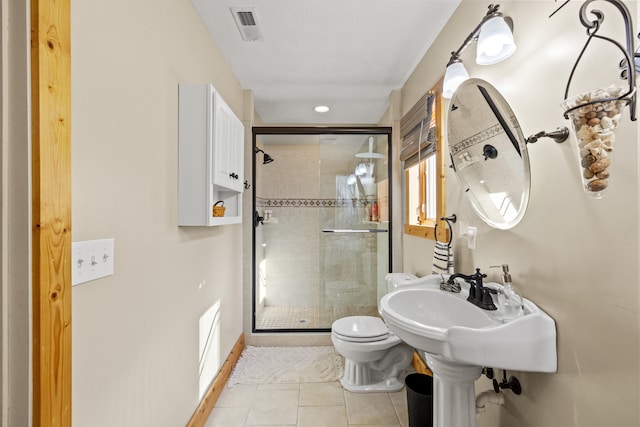 bathroom with toilet, walk in shower, and tile patterned flooring