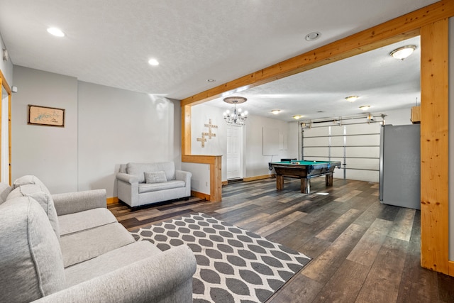 playroom featuring beamed ceiling, a notable chandelier, billiards, dark hardwood / wood-style floors, and a textured ceiling