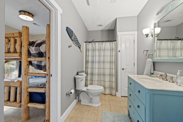 bathroom featuring toilet, tile patterned flooring, and vanity