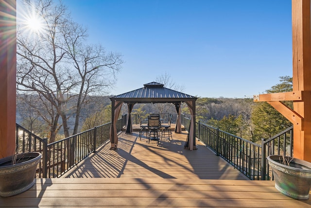 wooden terrace featuring a gazebo