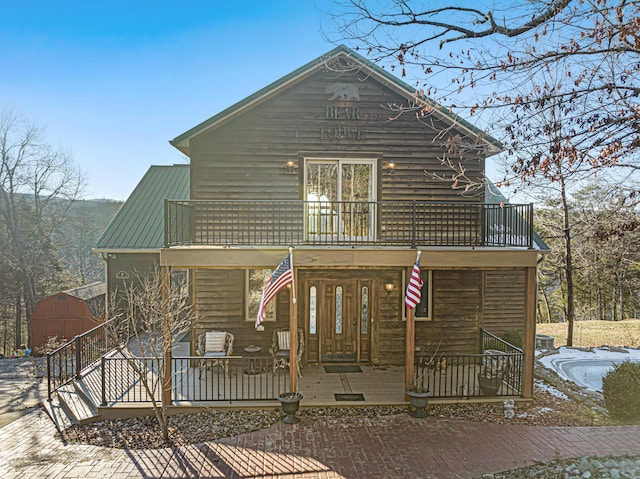 view of front of property with a porch and a balcony