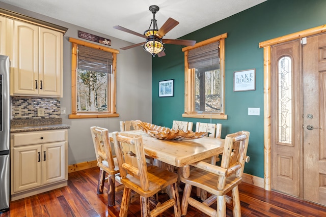 dining space with a wealth of natural light, ceiling fan, and dark hardwood / wood-style flooring