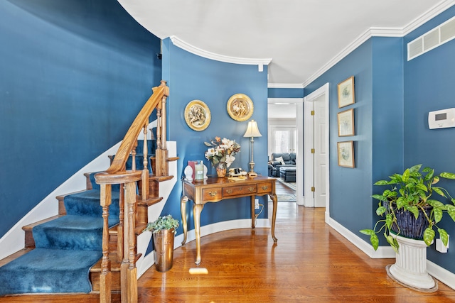 interior space featuring ornamental molding and hardwood / wood-style flooring