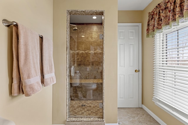 bathroom with an enclosed shower and tile patterned flooring