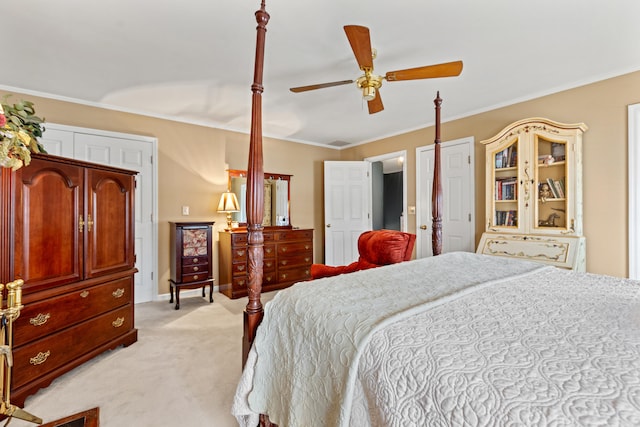 bedroom featuring ceiling fan, light colored carpet, and crown molding