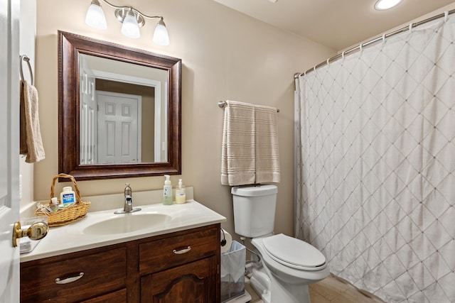 bathroom with walk in shower, tile patterned flooring, vanity, and toilet