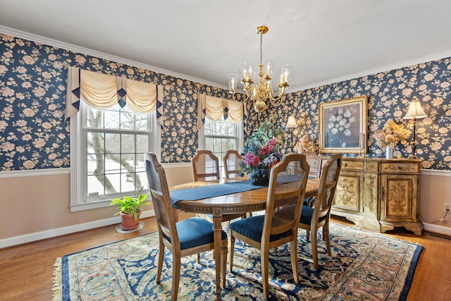 dining space with ornamental molding, an inviting chandelier, and wood-type flooring