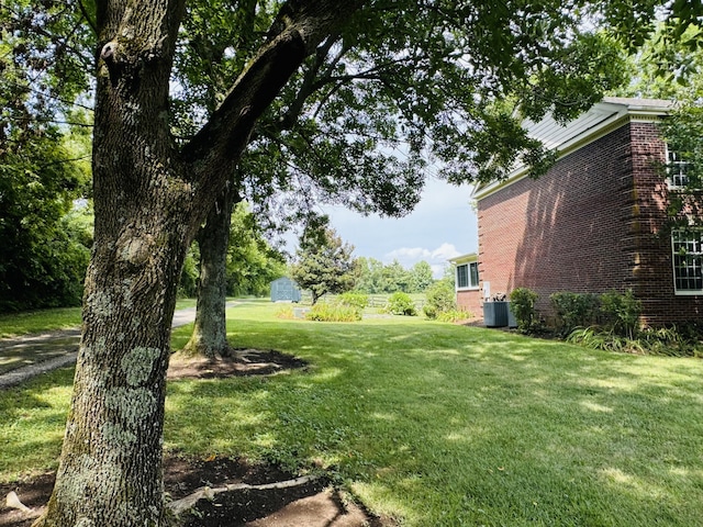 view of yard with a storage unit and central AC unit