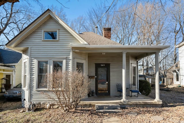 back of house featuring a porch