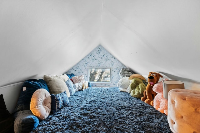 bedroom featuring lofted ceiling and carpet floors