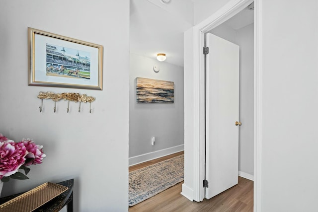 corridor with hardwood / wood-style flooring