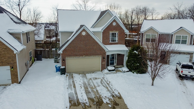 front of property with central AC unit and a garage