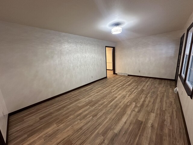 unfurnished room featuring hardwood / wood-style floors