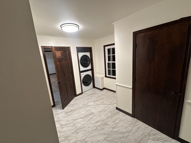 washroom featuring stacked washer and clothes dryer