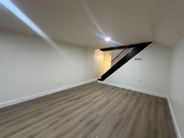 basement with hardwood / wood-style floors