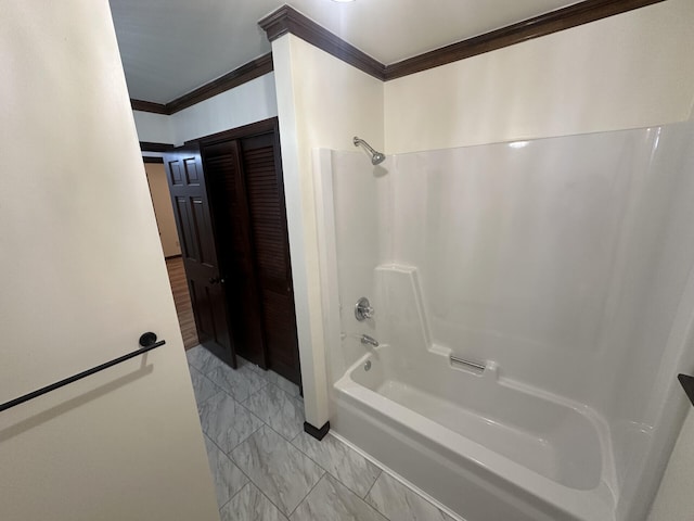 bathroom with ornamental molding and shower / tub combination