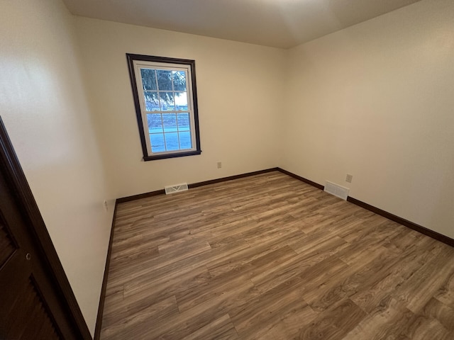 spare room with wood-type flooring