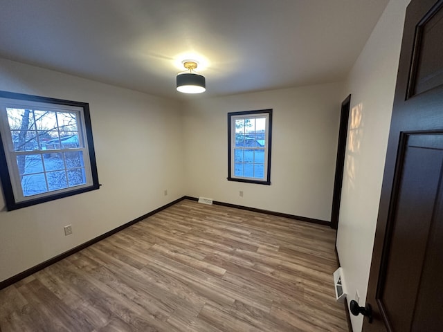 spare room featuring light wood-type flooring