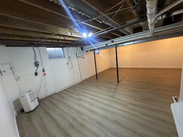 basement with hardwood / wood-style floors