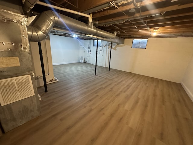 basement featuring wood-type flooring