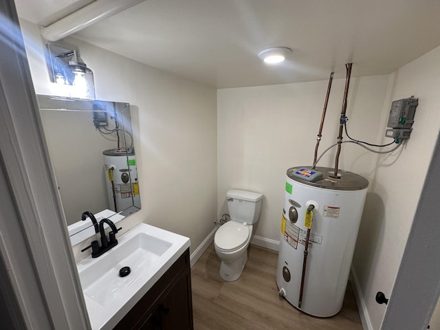 bathroom featuring hardwood / wood-style floors, water heater, vanity, and toilet