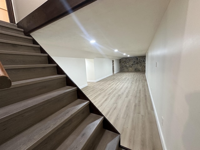 staircase with wood-type flooring