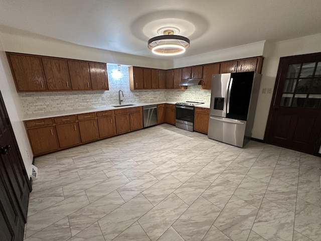 kitchen with stainless steel appliances, tasteful backsplash, and sink